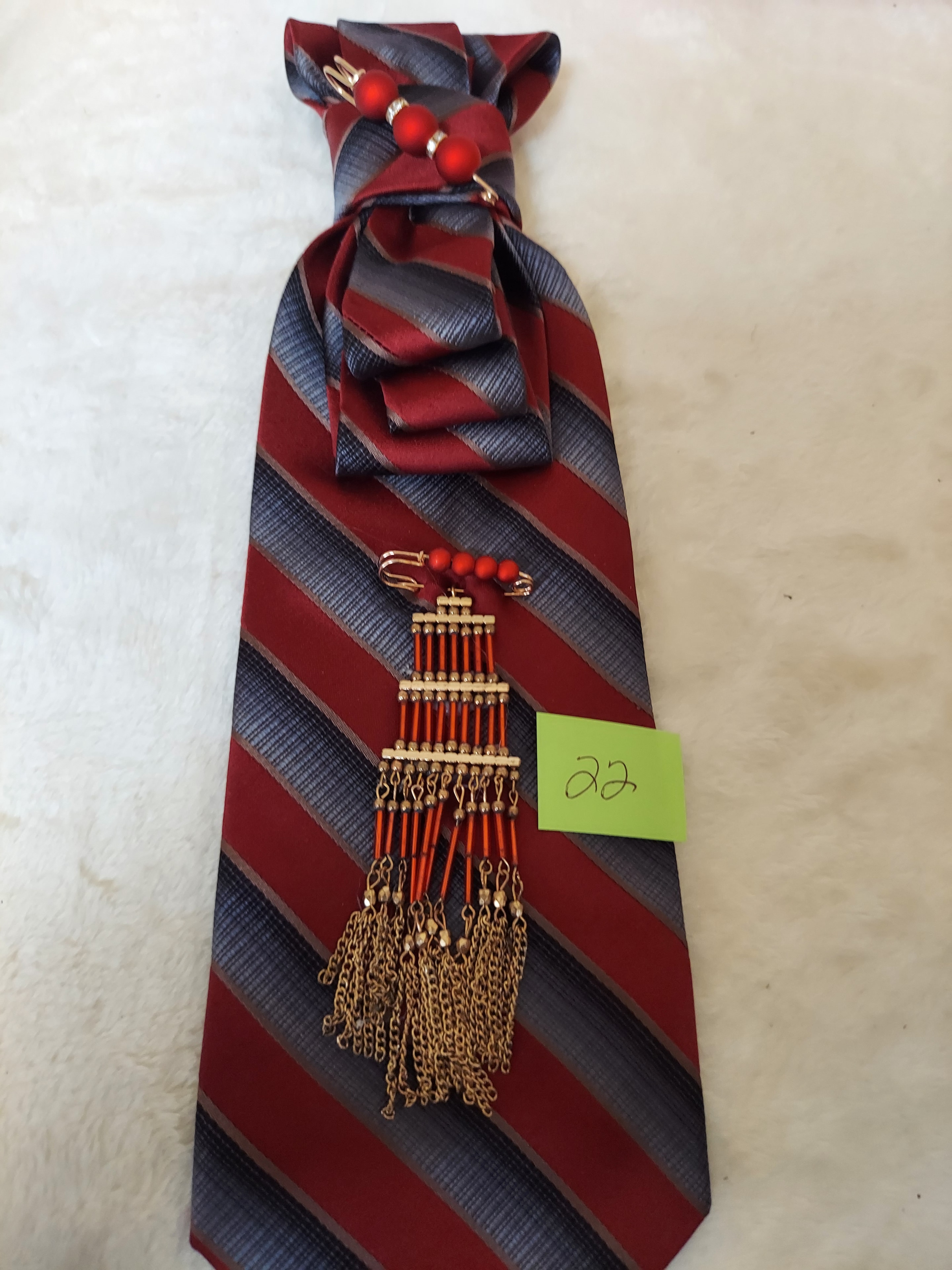 Red and navy striped tie with gold chain accessories